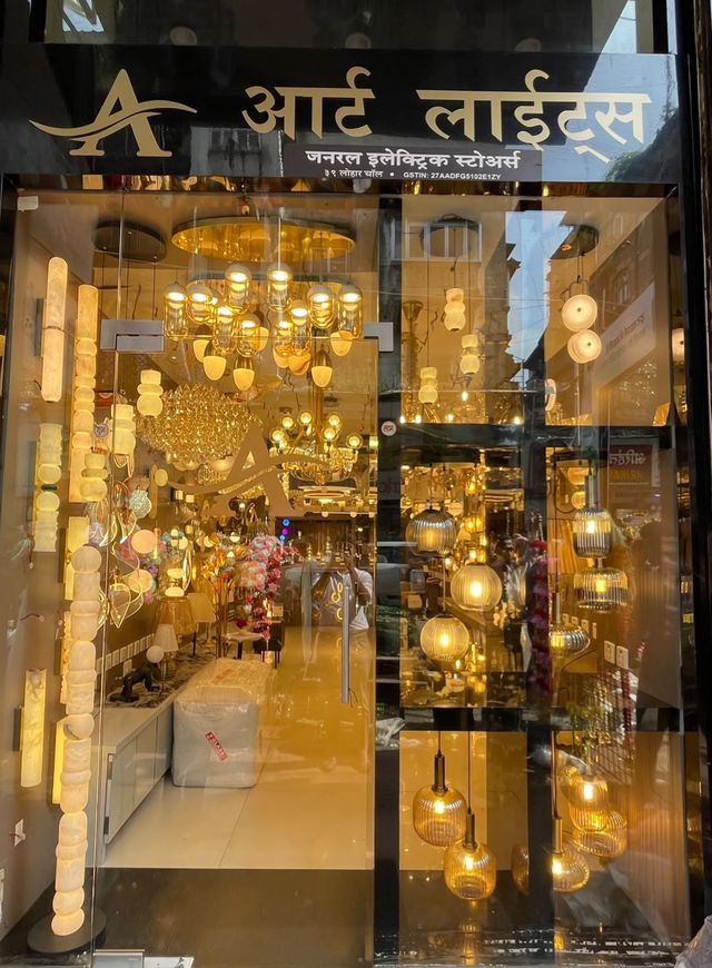 Art Lights showroom entrance at Lohar Chawl, Kalbadevi, with chandeliers and pendant lights glowing in the glass front